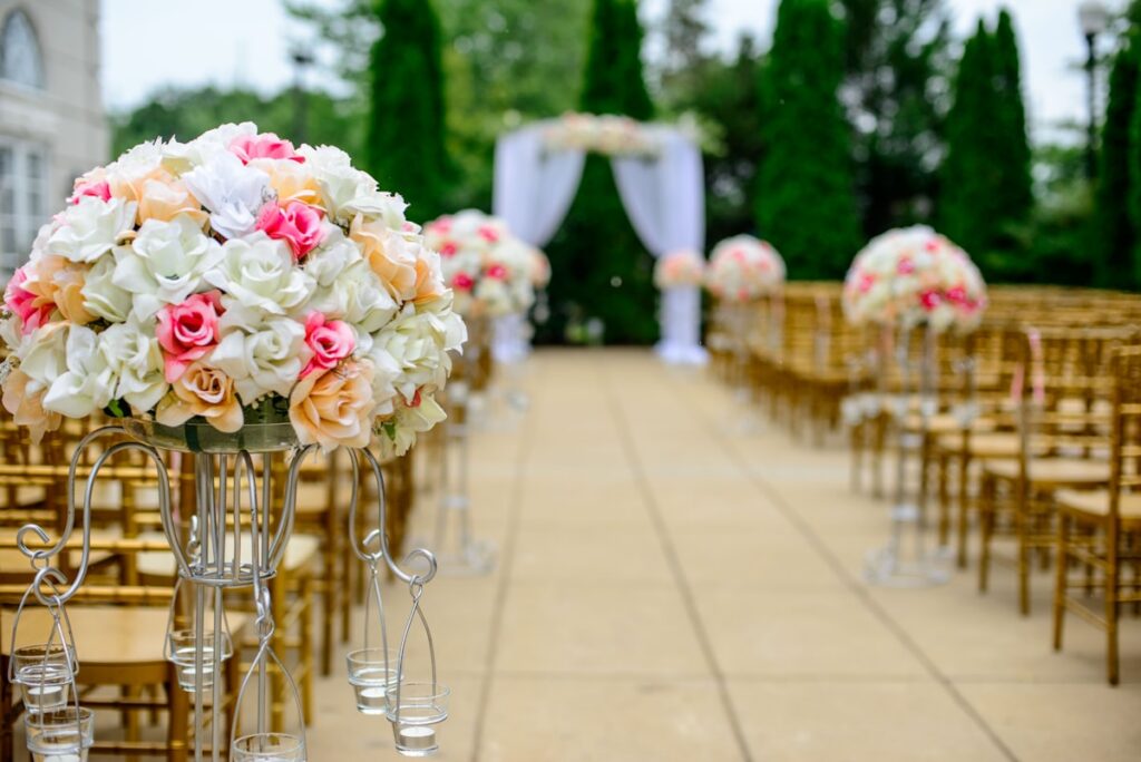 Wedding aisle with flower arrangements and chairs, wedding venue sales funnel