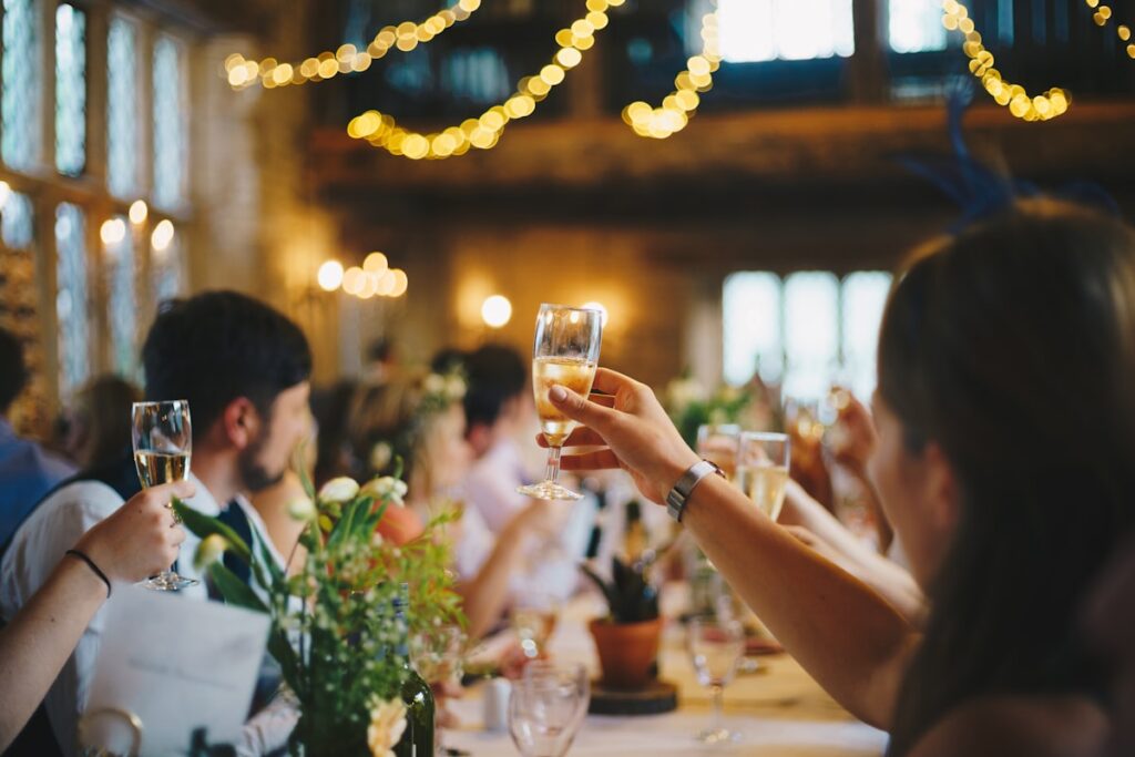 People toasting champagne at a wedding reception, illustrating speed to lead.
