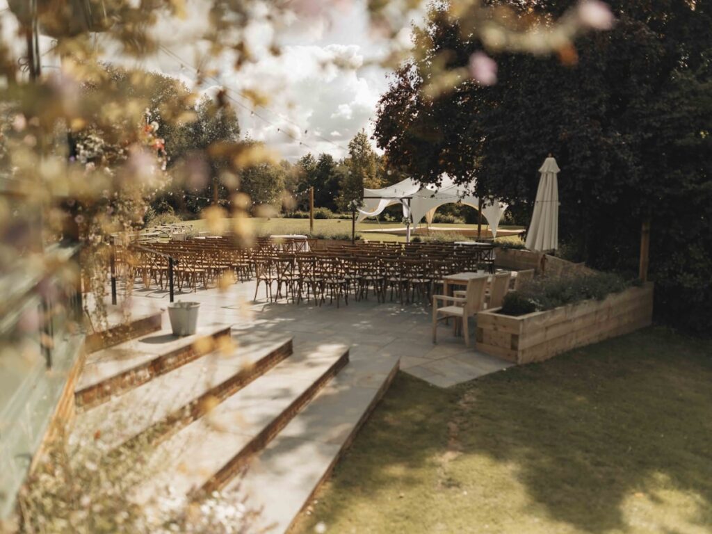 Outdoor wedding ceremony setup with chairs and a tent, ideal for event venue CRM.